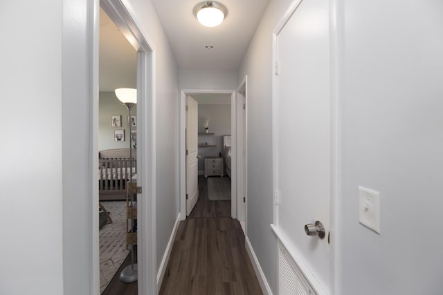 hallway featuring dark hardwood / wood-style flooring