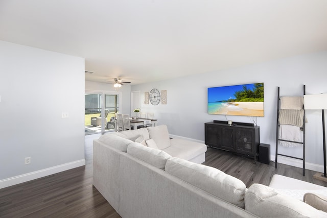 living area with a ceiling fan, visible vents, baseboards, and wood finished floors