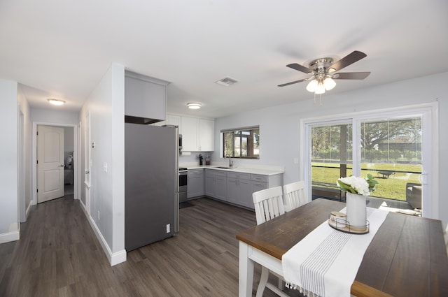 dining space featuring ceiling fan, sink, and dark hardwood / wood-style floors