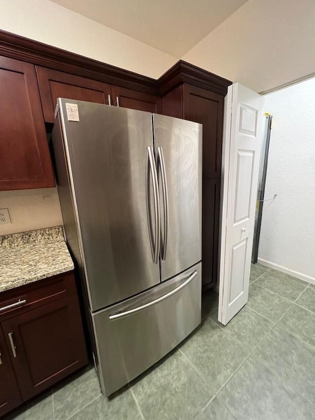 kitchen with stainless steel fridge and light stone counters