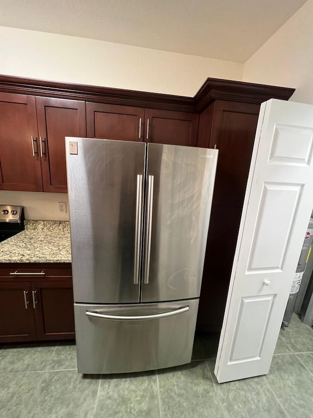 room details featuring light stone countertops, dark brown cabinetry, and appliances with stainless steel finishes