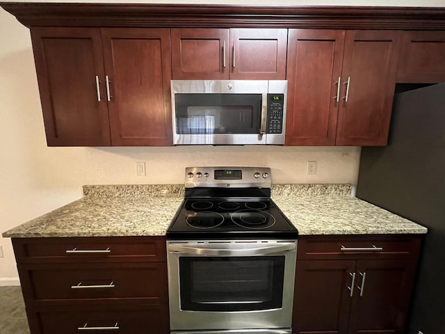 kitchen with light stone countertops and stainless steel appliances