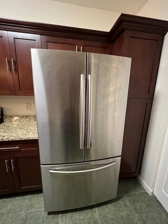 room details with light stone counters and stainless steel fridge