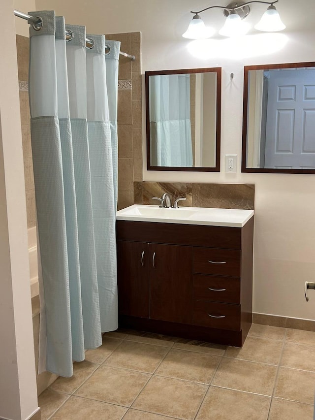 bathroom with tile patterned flooring, a shower with shower curtain, and vanity