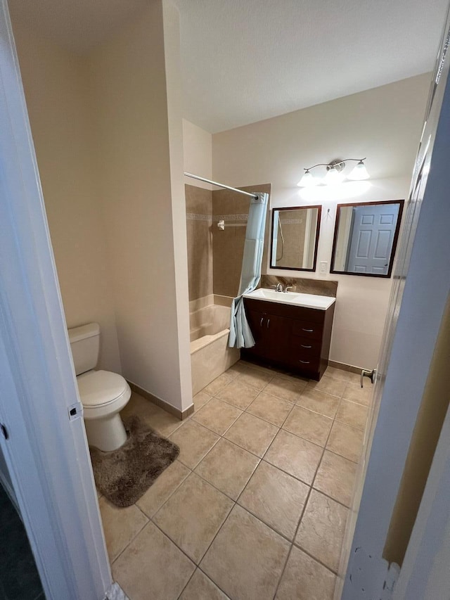 full bathroom with shower / bath combo with shower curtain, toilet, tile patterned floors, and vanity