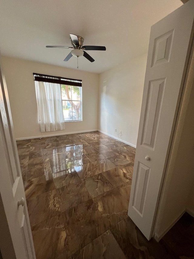 unfurnished room with ceiling fan