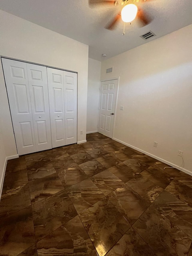 unfurnished bedroom featuring a closet and ceiling fan