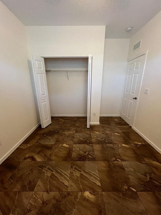 unfurnished bedroom featuring a closet