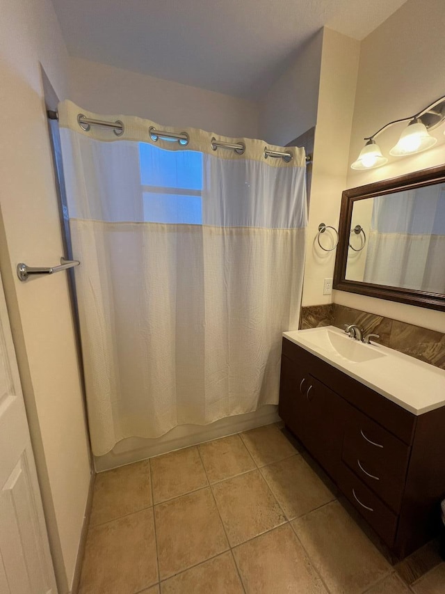 bathroom featuring tile patterned floors, vanity, and shower / tub combo with curtain