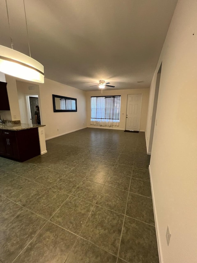 unfurnished living room with ceiling fan