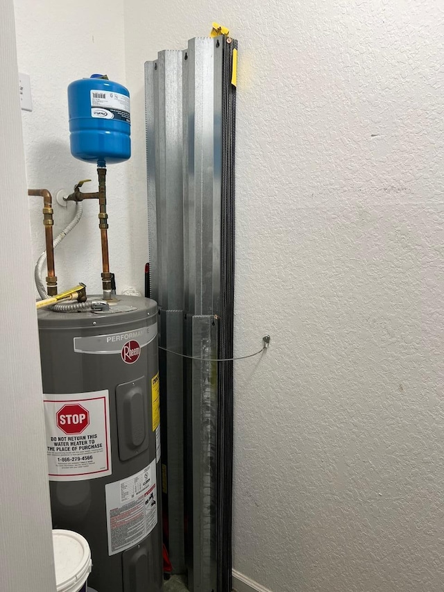 utility room featuring water heater