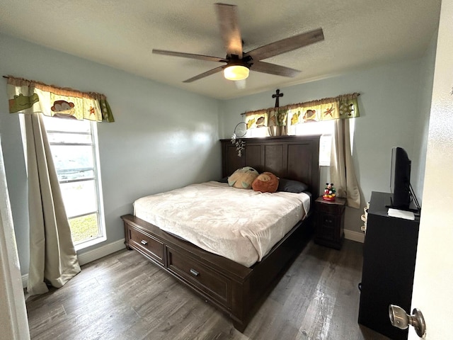 bedroom with multiple windows, hardwood / wood-style flooring, a textured ceiling, and ceiling fan