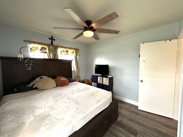 bedroom with dark wood-type flooring and ceiling fan