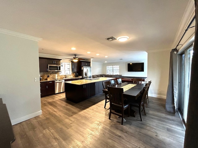 dining area featuring ornamental molding and hardwood / wood-style floors