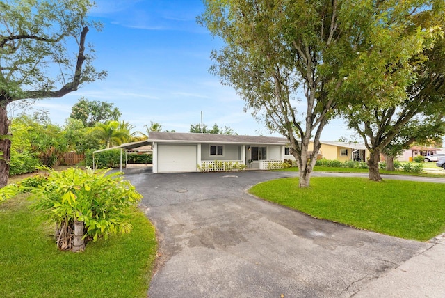 ranch-style house with a garage, a front yard, and a carport