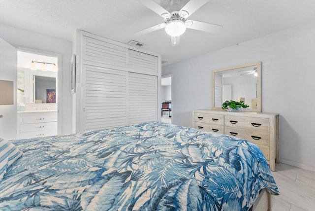 bedroom with a closet, ceiling fan, and ensuite bath