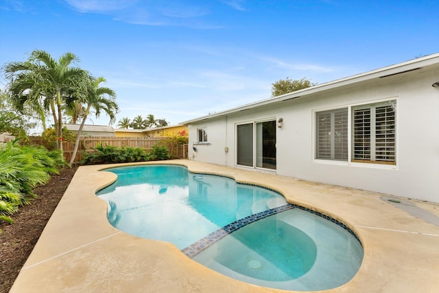 view of swimming pool featuring an in ground hot tub and a patio area