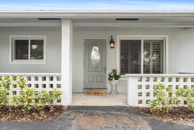 doorway to property featuring covered porch