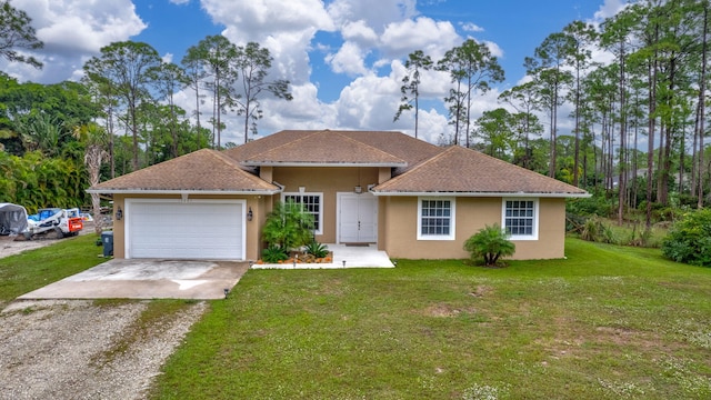 ranch-style house featuring a garage and a front lawn