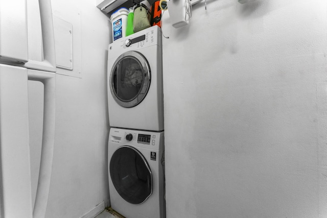 laundry room featuring stacked washer / drying machine