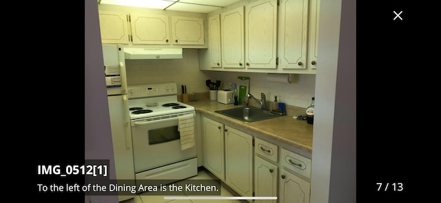 kitchen featuring sink, white electric range oven, and backsplash