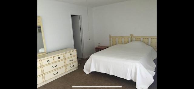 bedroom with dark colored carpet