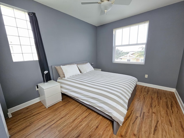 bedroom with hardwood / wood-style floors and ceiling fan