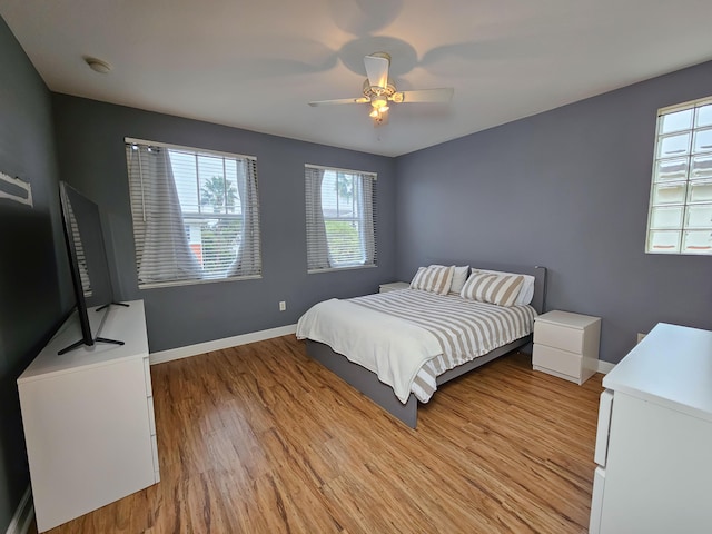 bedroom featuring light hardwood / wood-style flooring and ceiling fan