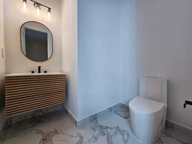 bathroom featuring toilet and vanity