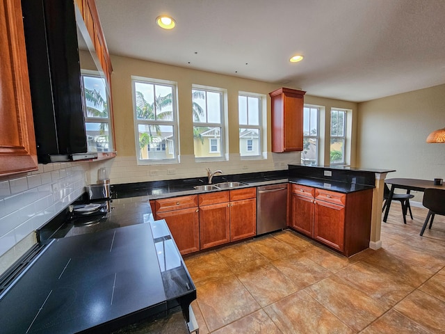 kitchen with tasteful backsplash, light tile patterned floors, stainless steel dishwasher, sink, and kitchen peninsula