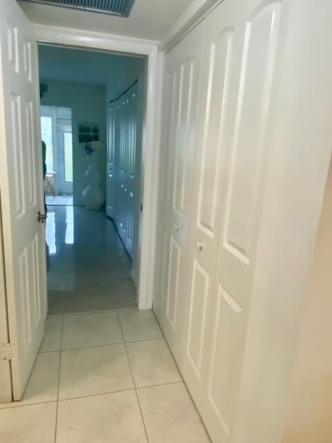 hallway with light tile patterned floors