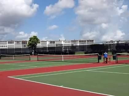 view of tennis court featuring basketball court