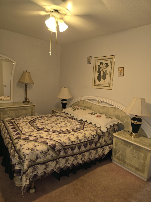 bedroom featuring ceiling fan and carpet