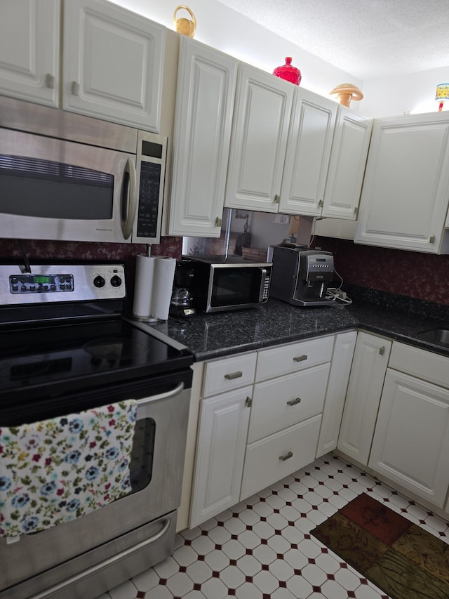 kitchen featuring white cabinetry and appliances with stainless steel finishes