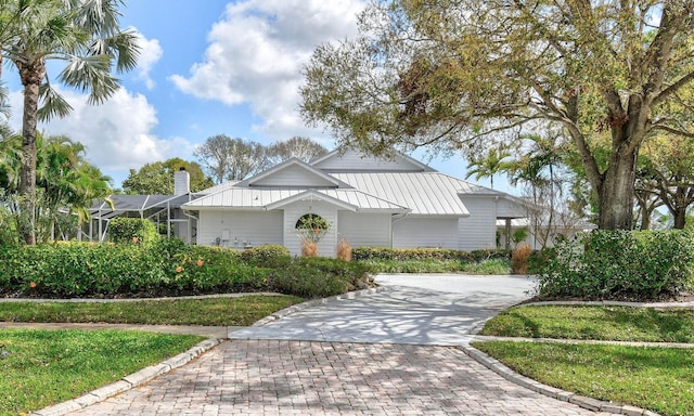 view of front of property with a lanai and a front lawn