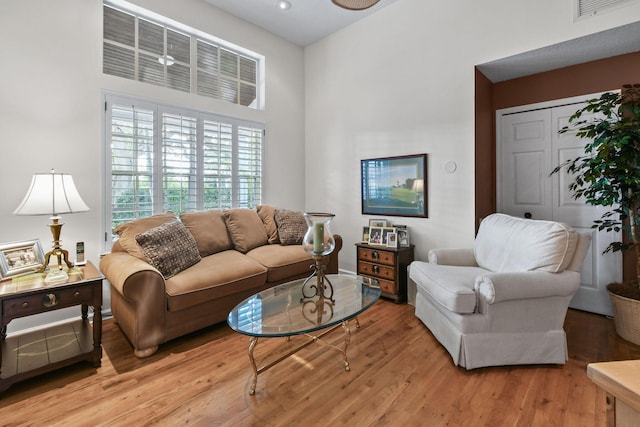 living area with light wood-style flooring and visible vents