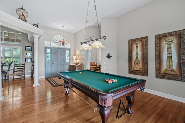 playroom featuring light wood-style floors, baseboards, and ornate columns