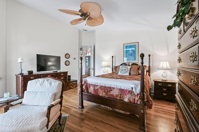 bedroom featuring ceiling fan, wood finished floors, and visible vents