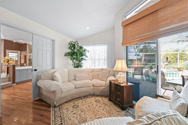 living area featuring lofted ceiling and wood finished floors