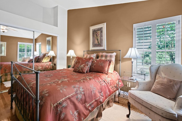 bedroom featuring lofted ceiling, a closet, and wood finished floors