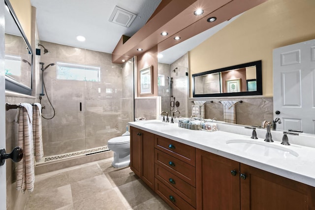 bathroom featuring a stall shower, visible vents, and a sink