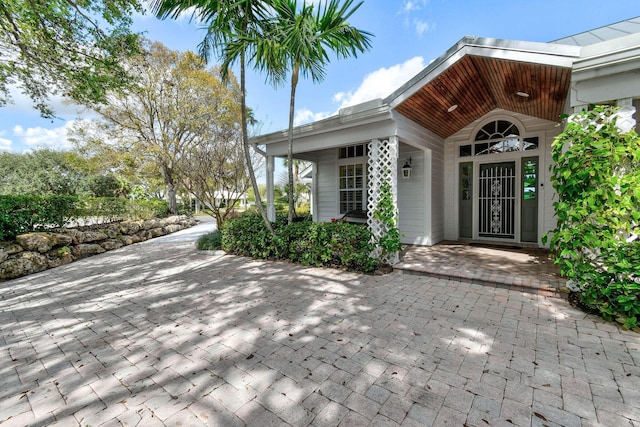 view of exterior entry with covered porch