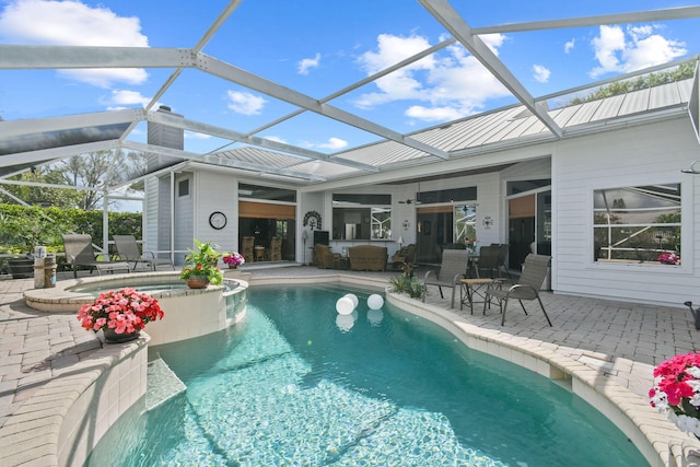 outdoor pool featuring a patio area and an in ground hot tub