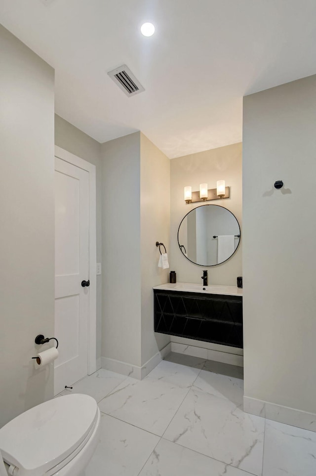 bathroom with vanity and toilet