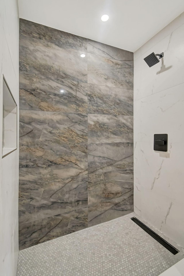 bathroom with a tile shower