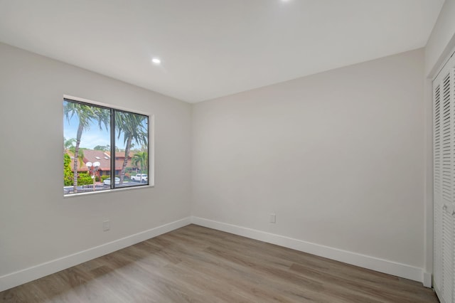 unfurnished bedroom featuring hardwood / wood-style floors and a closet