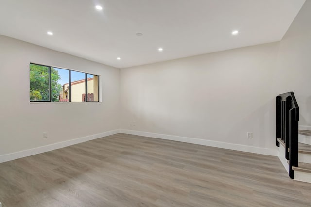 empty room with light hardwood / wood-style flooring