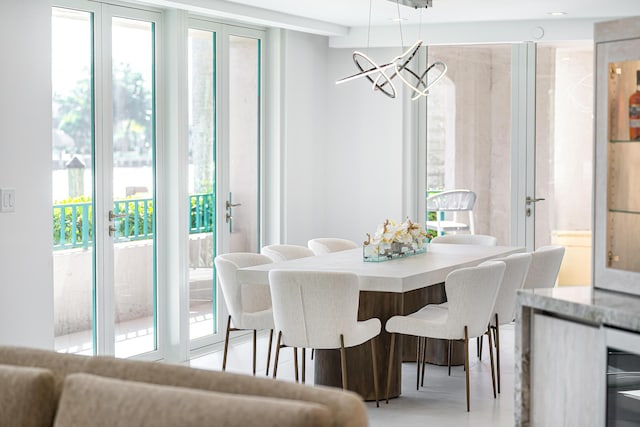 dining space featuring a healthy amount of sunlight and an inviting chandelier