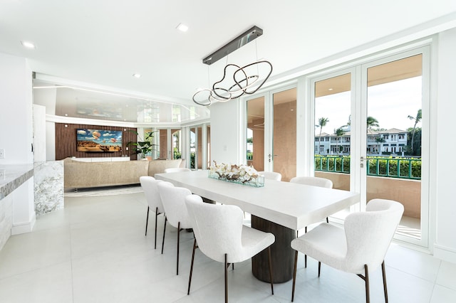 tiled dining space featuring a chandelier