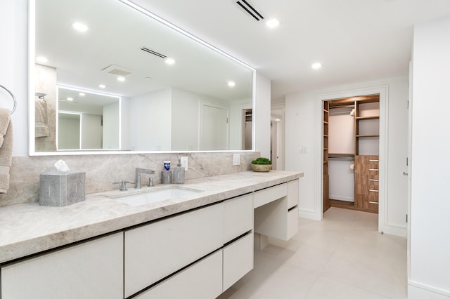 bathroom with tasteful backsplash and vanity